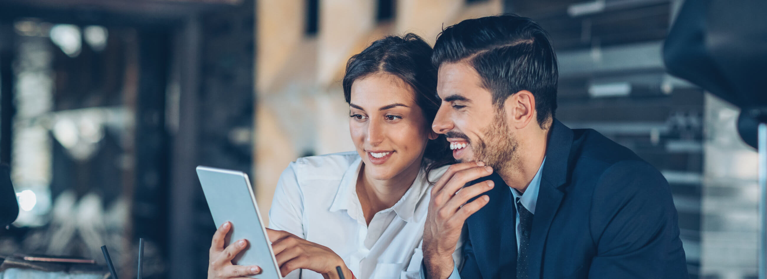 two business associates looking at a tablet device